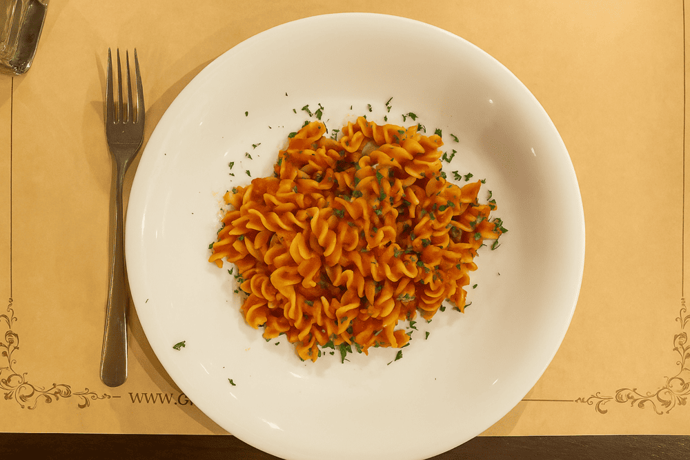 Restaurant features a vintage-style space with warm yellow walls and nostalgic black-and-white Italian photographs lining the walls